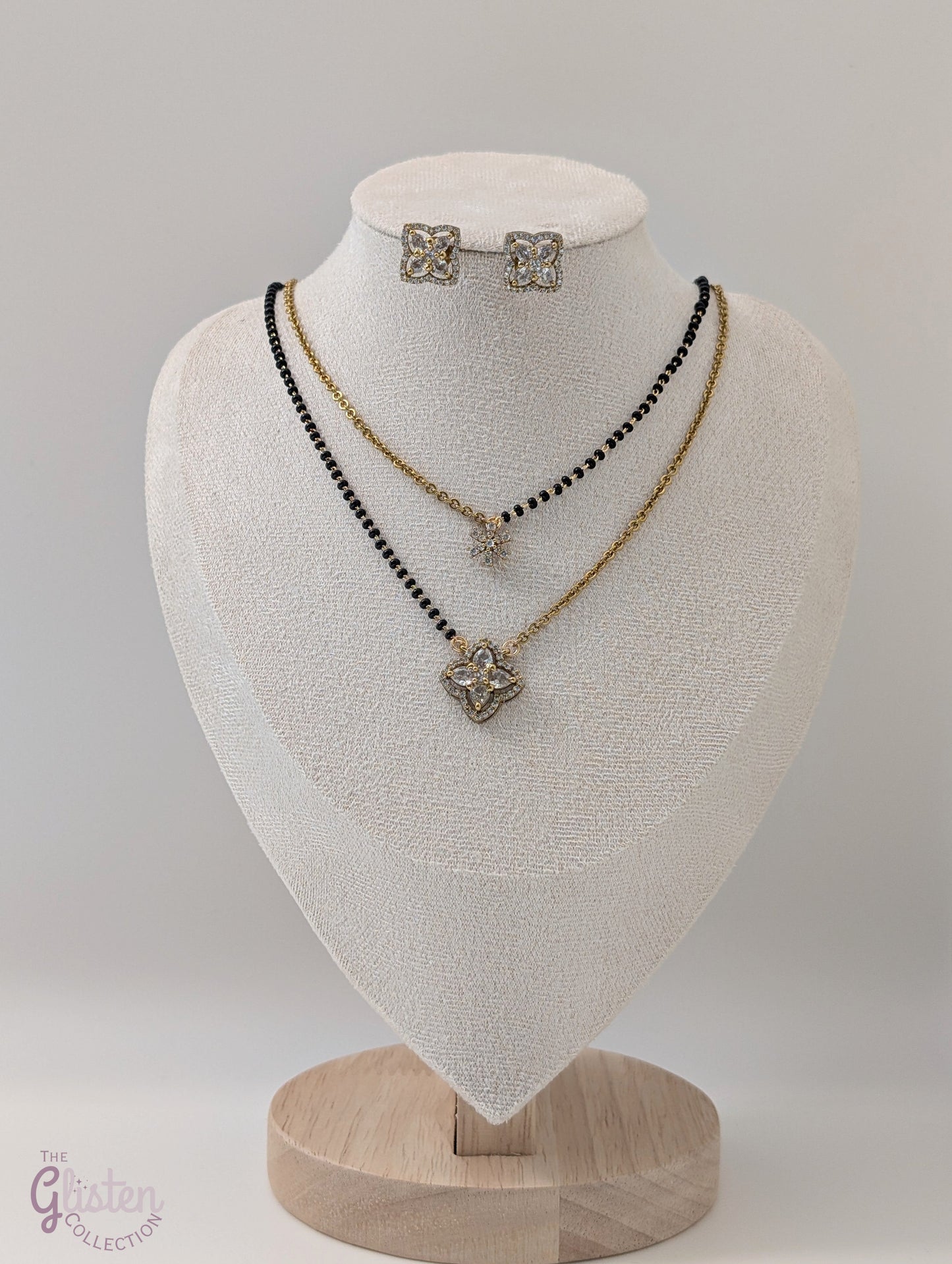 Layered black bead necklace set with Moissanite floral designs and simple matching earrings — perfect for daily wear and traditional occasions.
