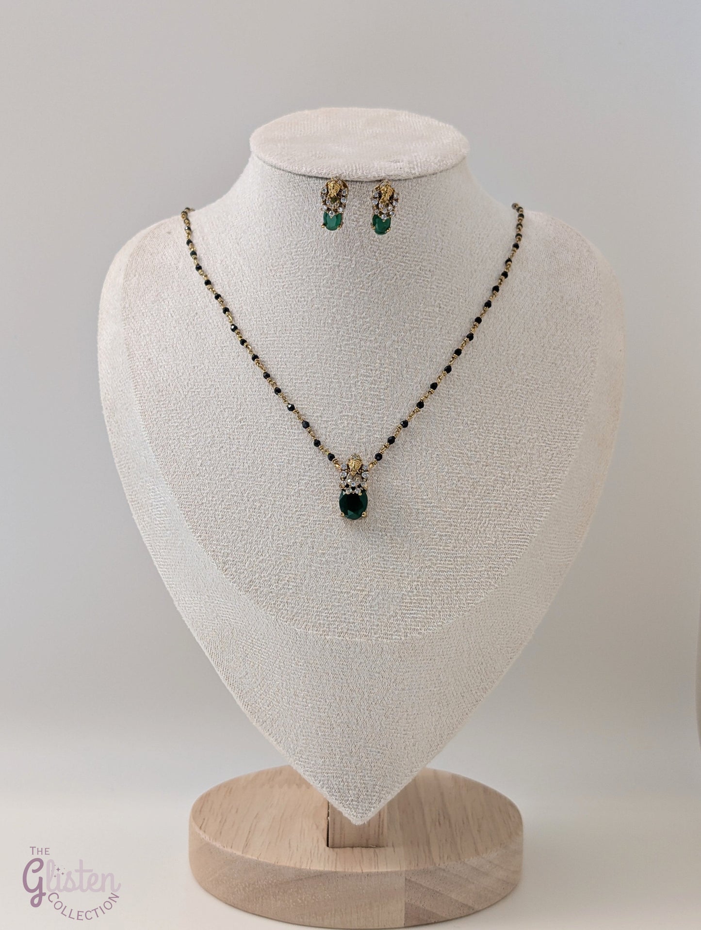 Black bead necklace with green stone pendant and matching earrings — minimal design ideal for daily wear and casual occasions.