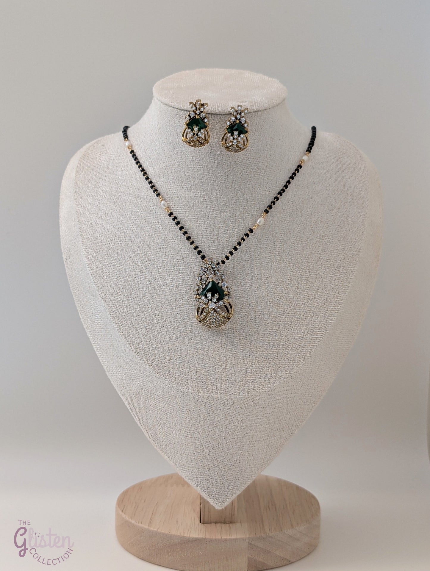 Bead-linked necklace with central green stone and matching earrings — elegant jewellery for festive and everyday wear.