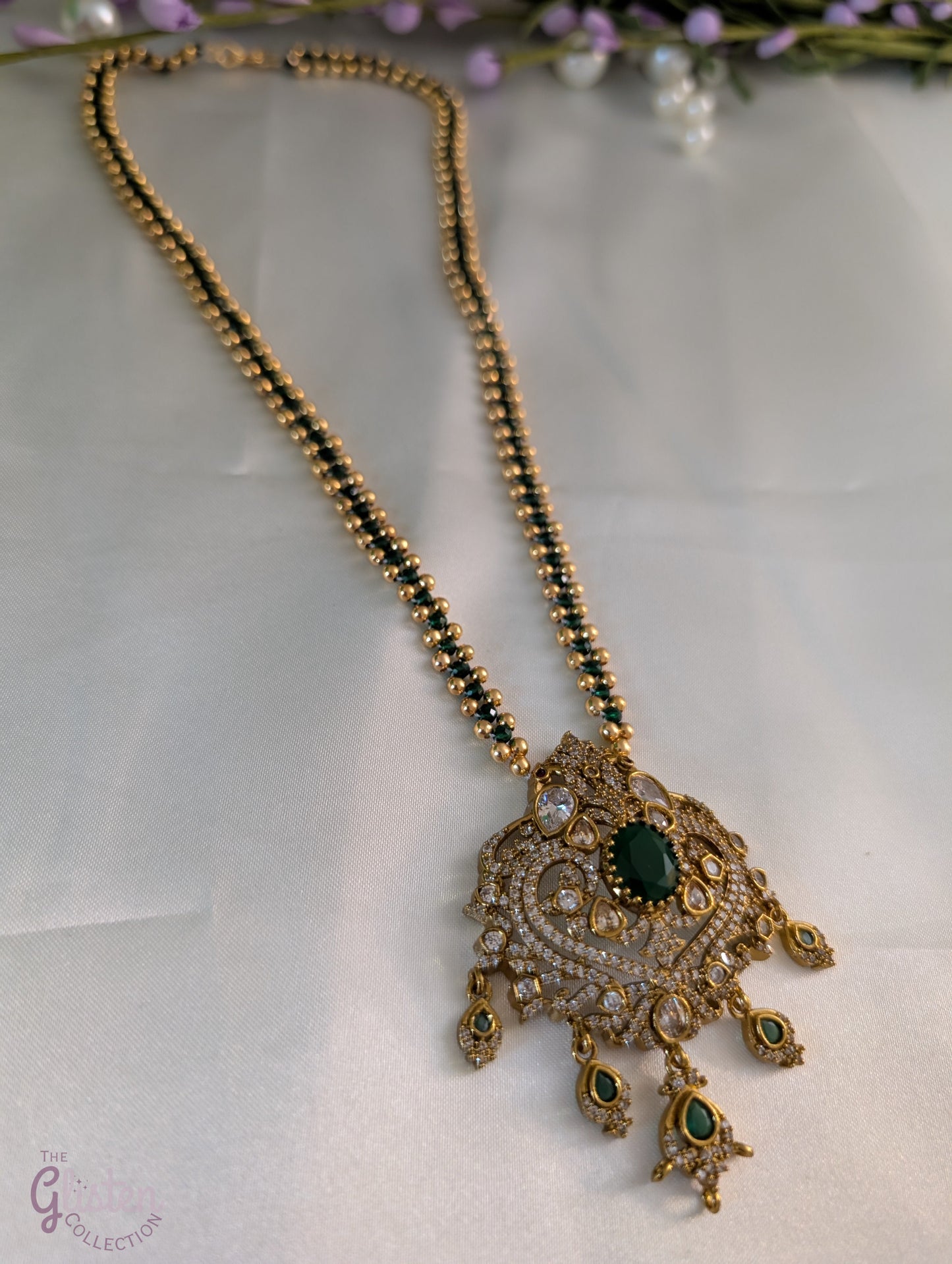 Green color chain necklace with ornate CZ pendant and dangling green stones — elegant festive jewellery for all ages, perfect for weddings and celebrations.
