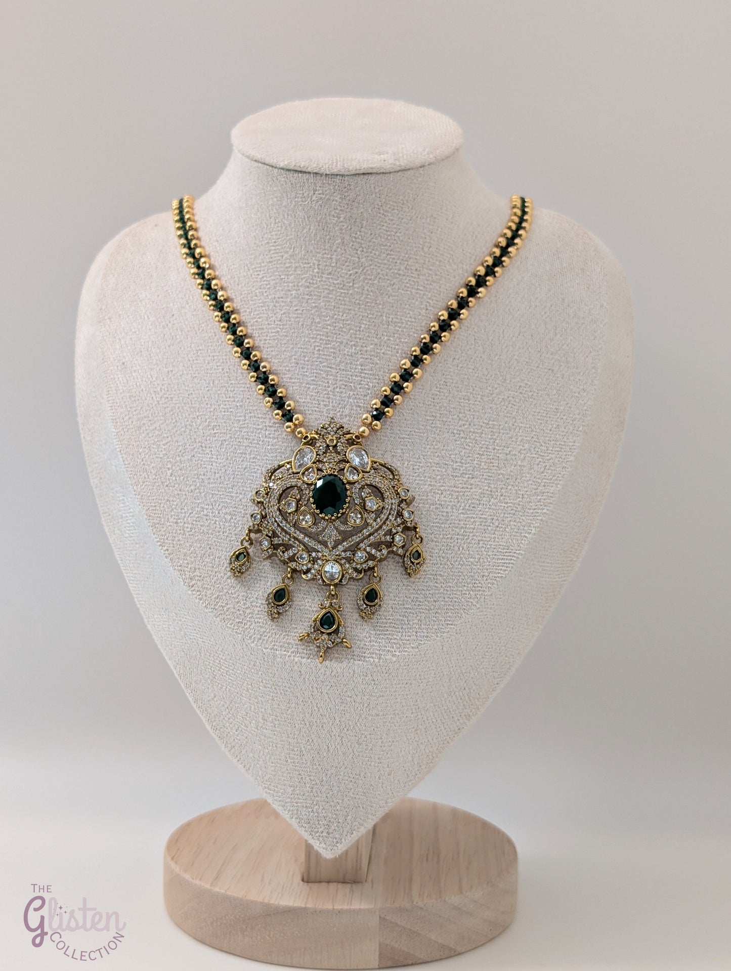 Green color chain necklace with ornate CZ pendant and dangling green stones — elegant festive jewellery for all ages, perfect for weddings and celebrations.