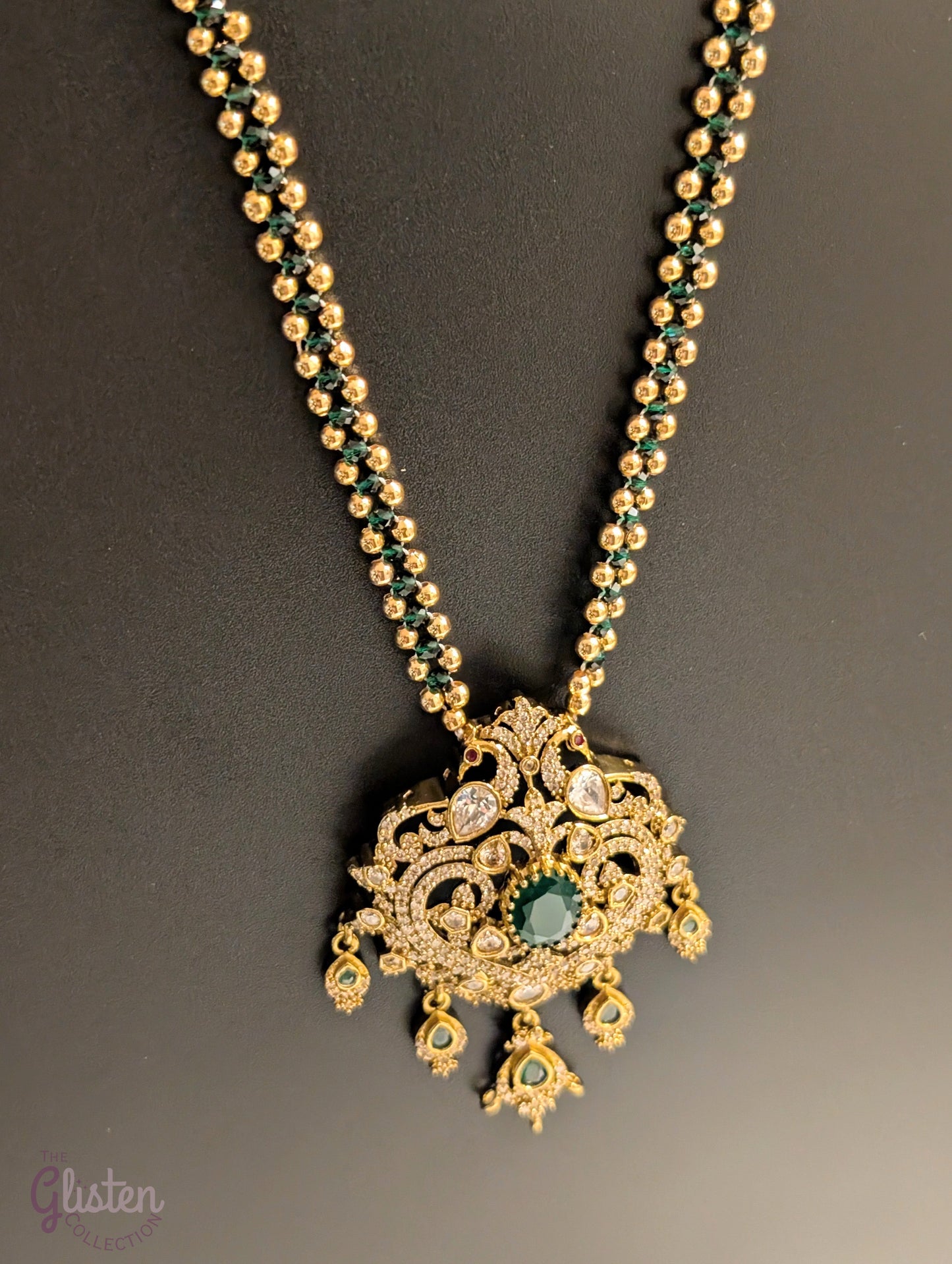 Green color chain necklace with ornate CZ pendant and dangling green stones — elegant festive jewellery for all ages, perfect for weddings and celebrations.