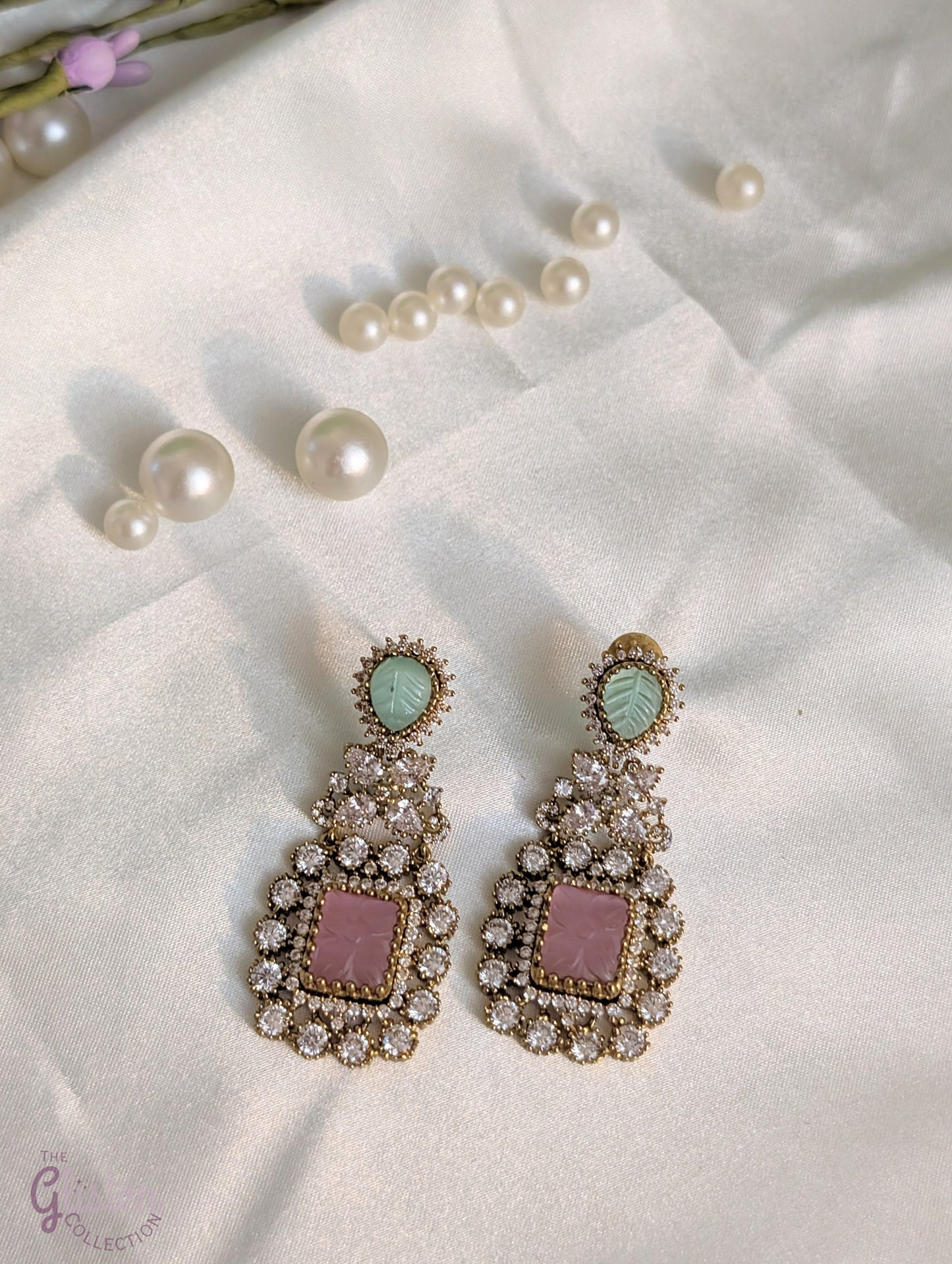 Rose Dew Drops earrings with pink square base, green tear-drop top, and Moissanite stones — ideal for modern or traditional occasions.