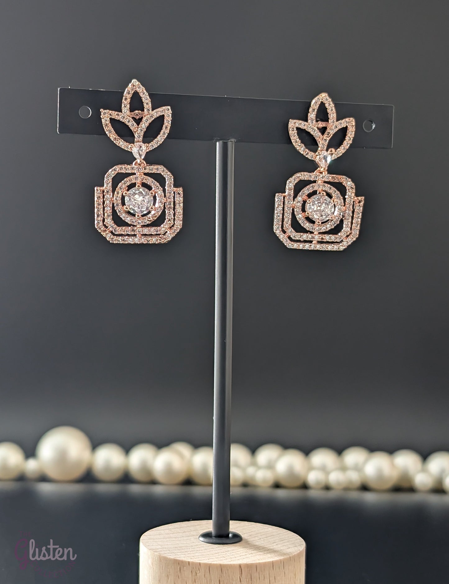 Rose gold-plated earrings with American diamond stones in leaf and teardrop design — perfect blend of traditional and contemporary elegance.