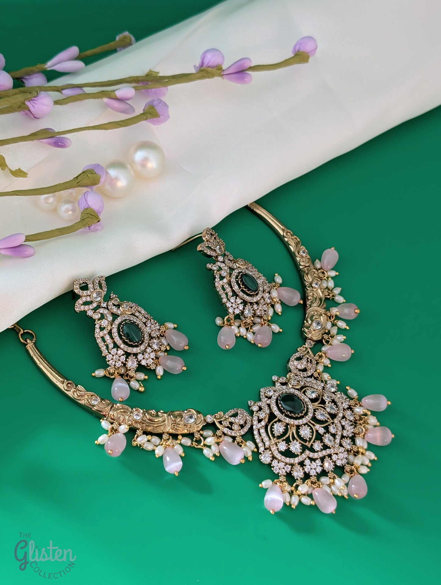 Statement necklace and earrings set with green center stone, pink beads, and white accents — perfect for weddings, festive looks, and party wear.