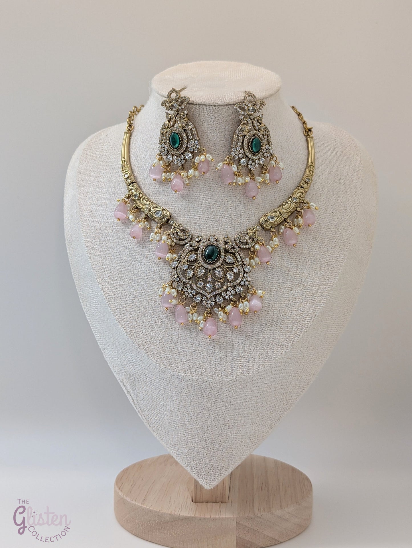 Statement necklace and earrings set with green center stone, pink beads, and white accents — perfect for weddings, festive looks, and party wear.