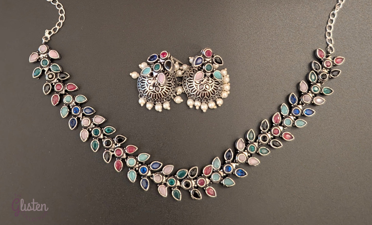 Leaf design oxidized German silver necklace set with colorful teardrop stones and matching pearl jhumkas — perfect for simple ethnic wear or festive style.