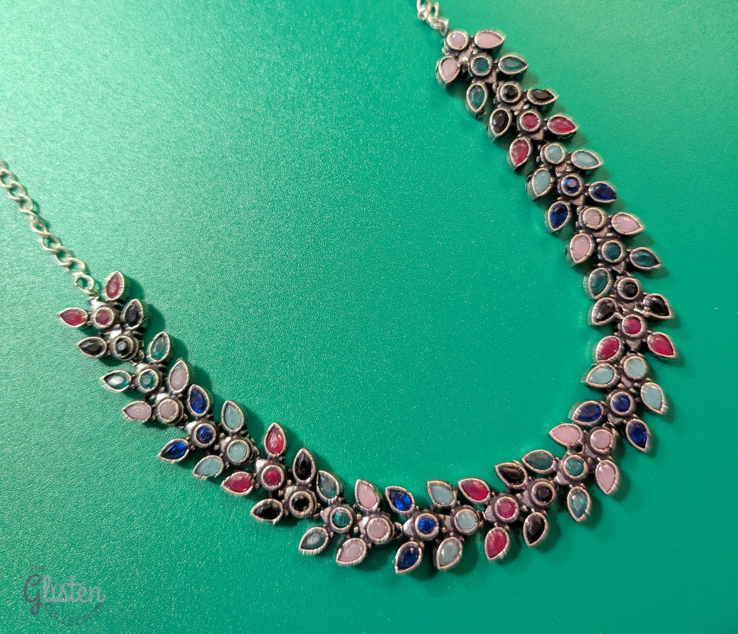 Leaf design oxidized German silver necklace set with colorful teardrop stones and matching pearl jhumkas — perfect for simple ethnic wear or festive style.