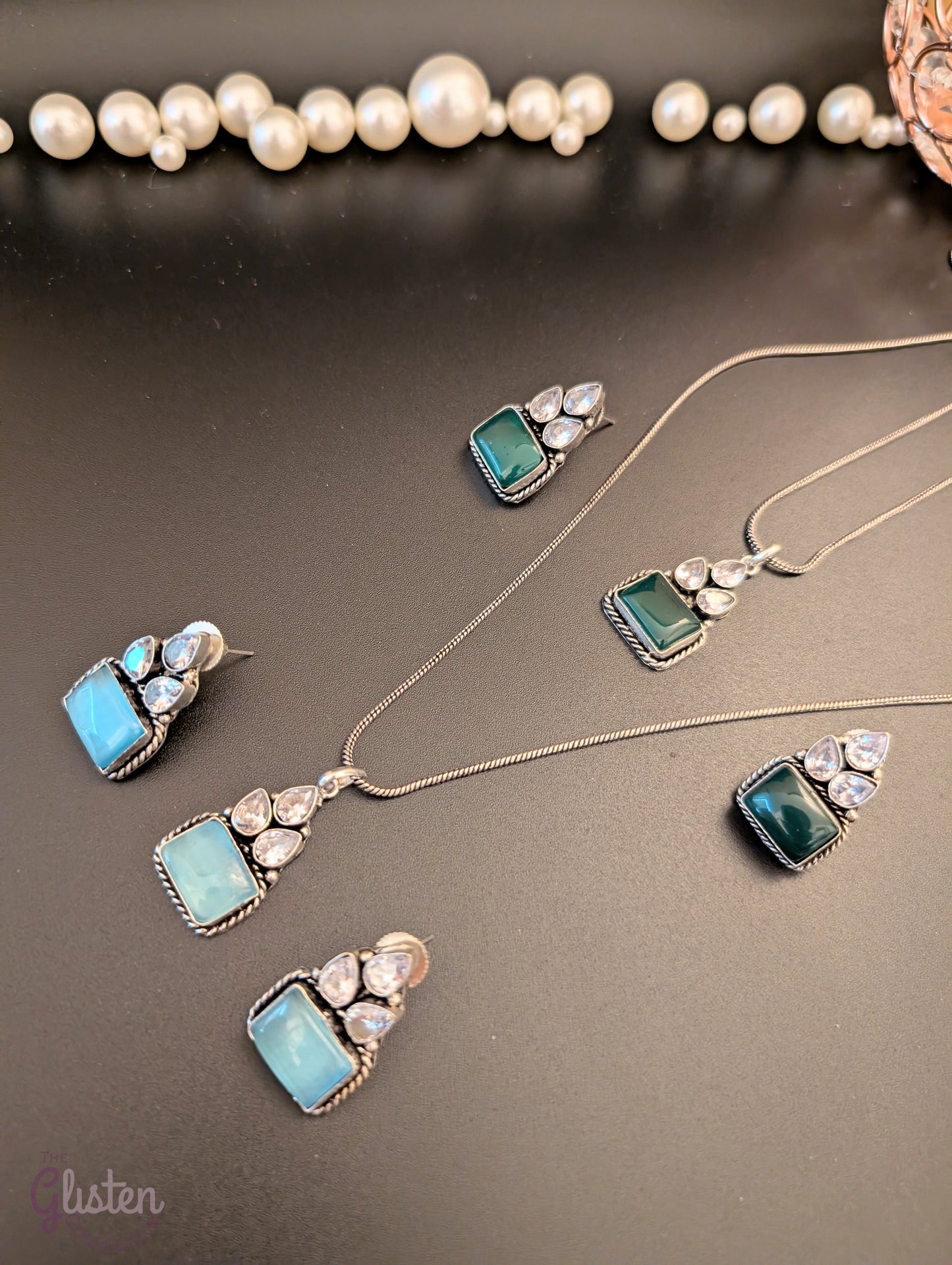 Oxidized silver pendant set with rectangular green stones, twisted rope frame, and American Diamonds — perfect for festive, ethnic, or everyday looks.