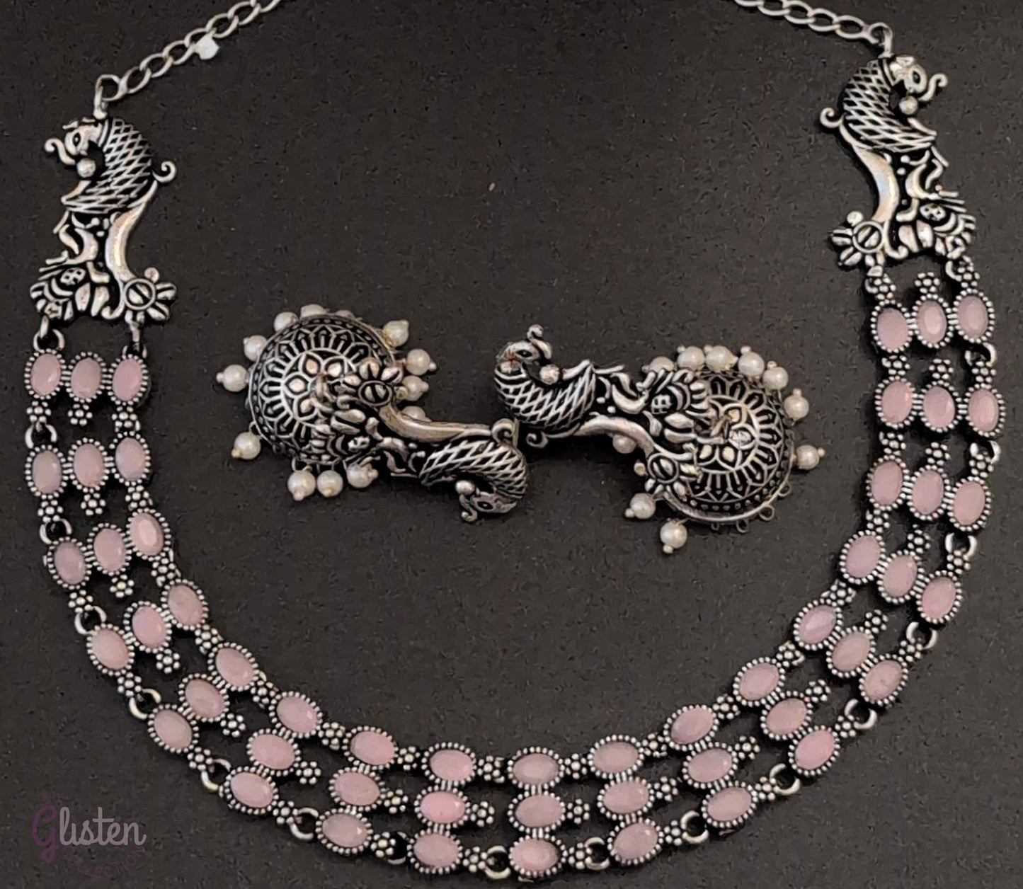Three-layered oxidized German silver necklace with peacock motifs and matching pearl jhumkas — ideal for weddings, traditional functions, and festive occasions.
