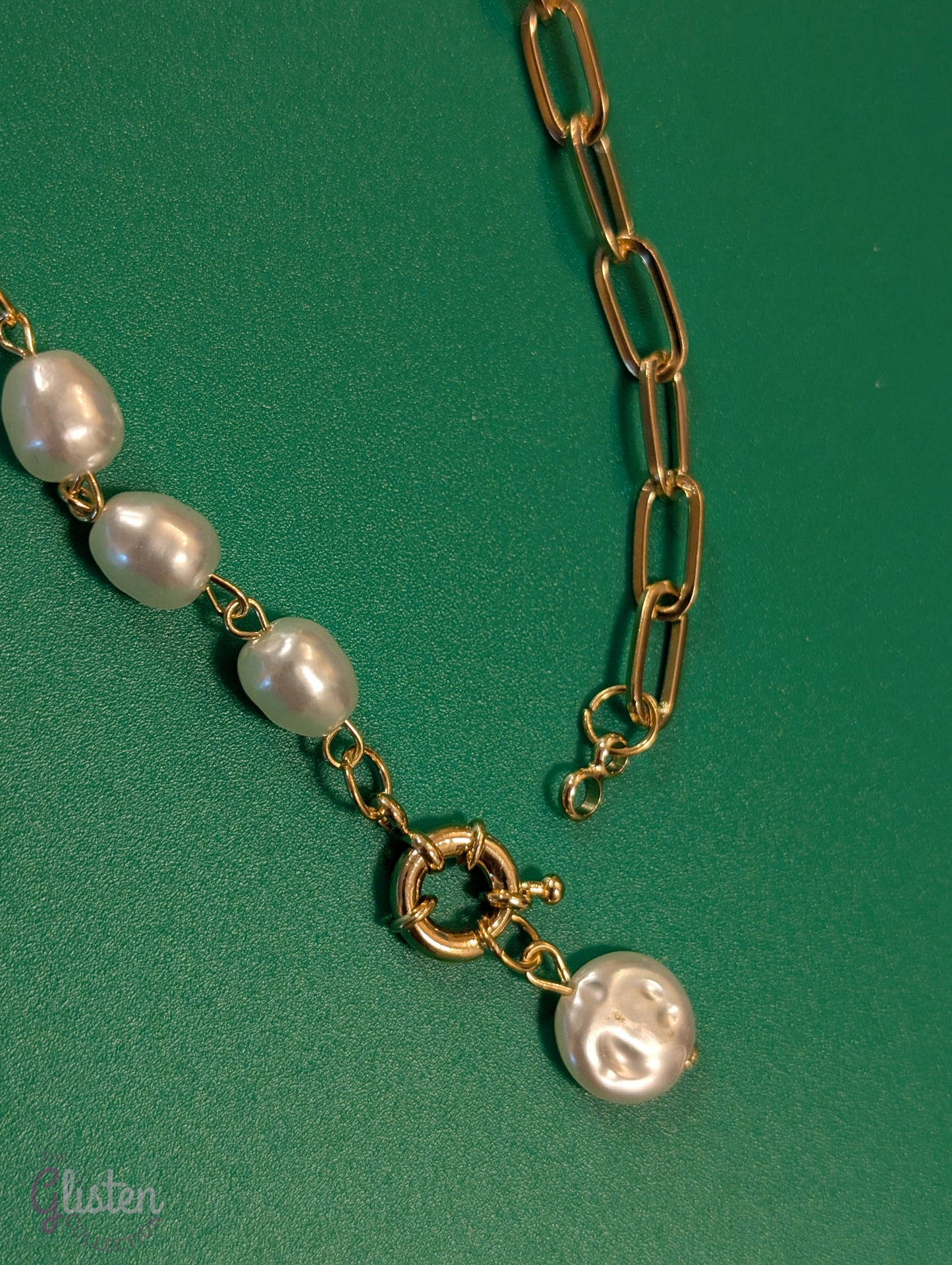 Minimalist round imitation pearl pendant necklace with unique bottom-opening mechanism.