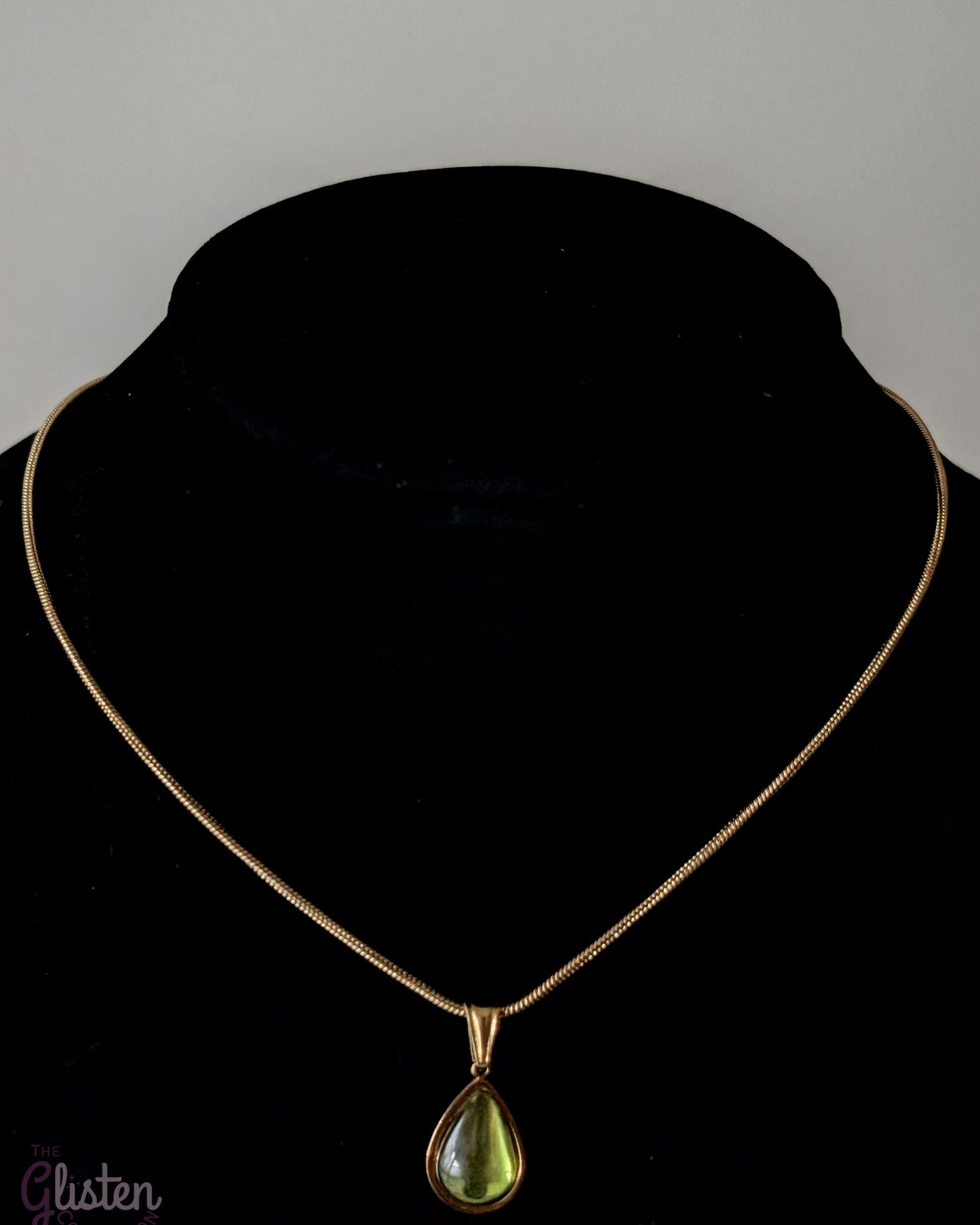 Elegant green glass droplet pendant necklace with stainless steel and 18K gold plating, offering a minimalist and refined look.