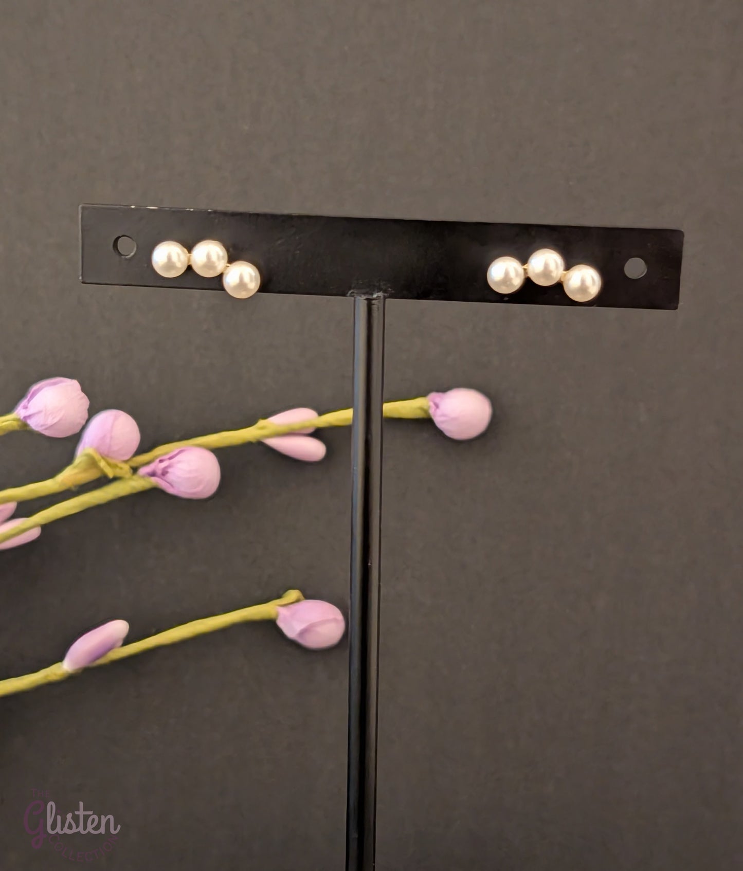 Round gold-plated pearl stud earrings with a minimalist design for everyday and office wear.