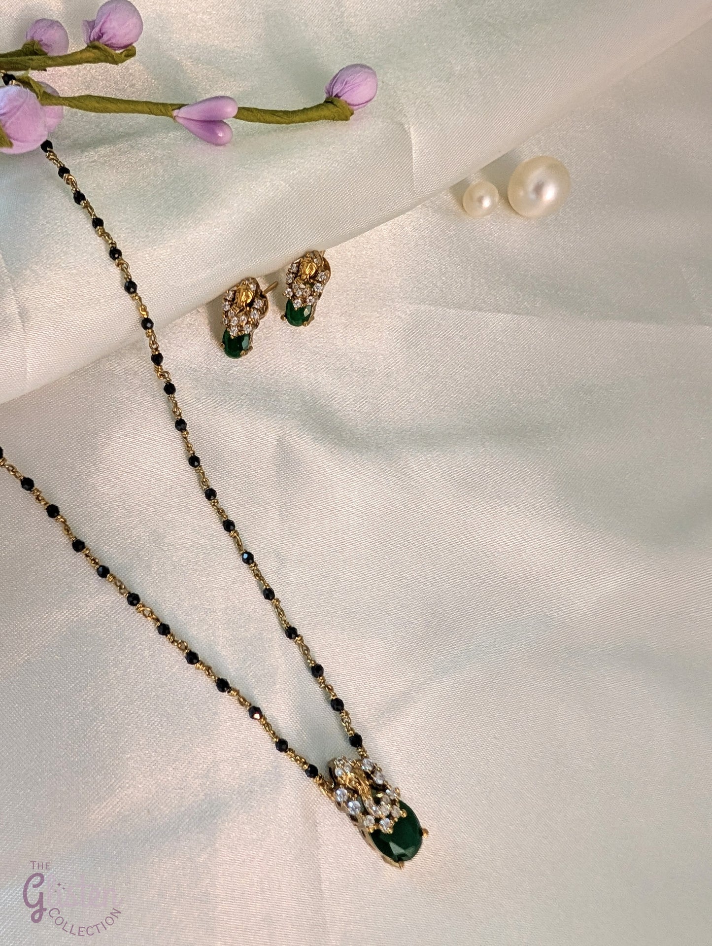 Black bead necklace with green stone pendant and matching earrings — minimal design ideal for daily wear and casual occasions.
