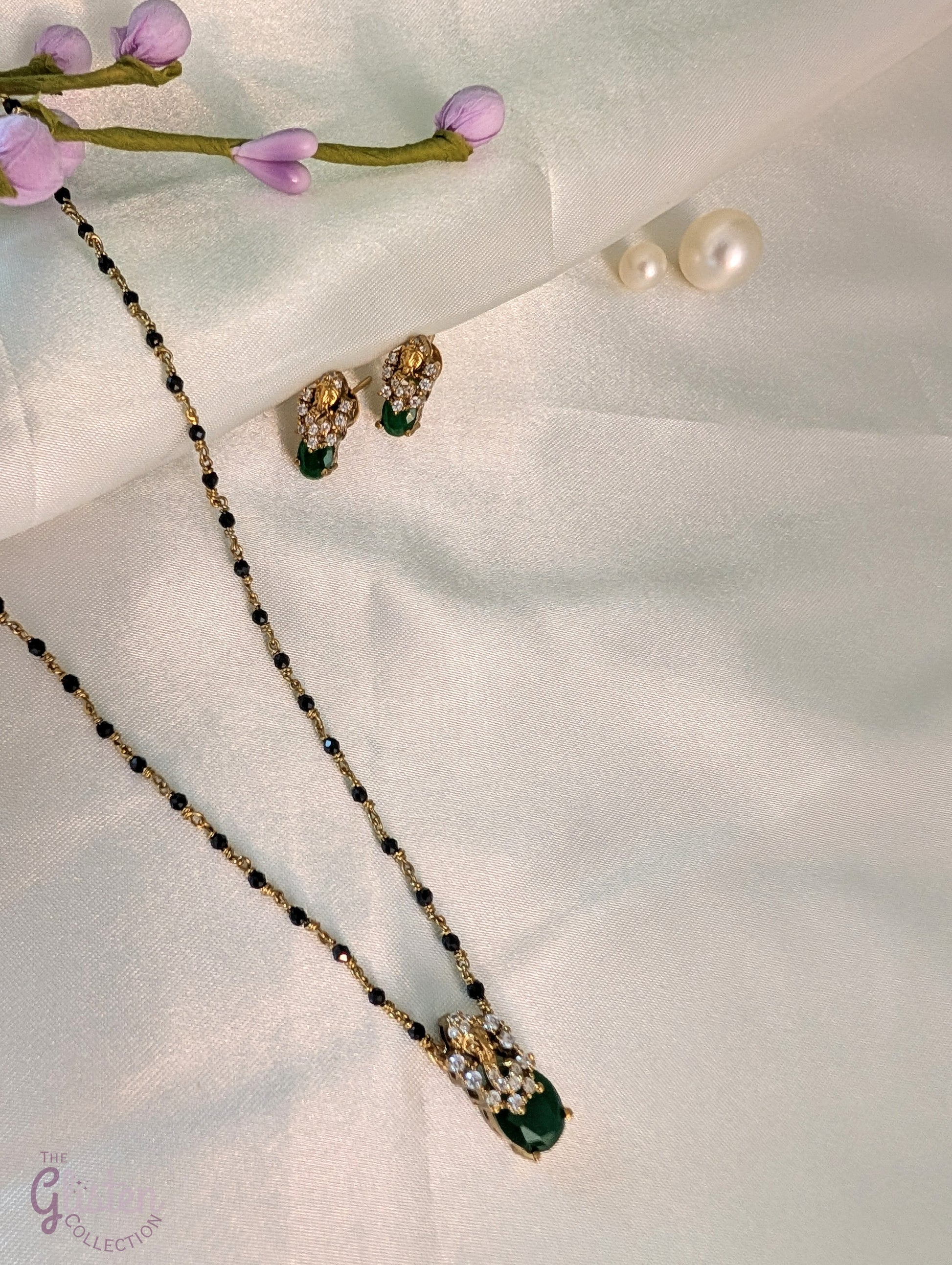 Black bead necklace with green stone pendant and matching earrings — minimal design ideal for daily wear and casual occasions.