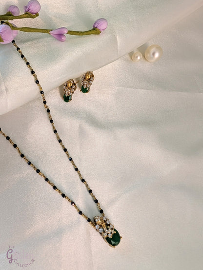 Black bead necklace with green stone pendant and matching earrings — minimal design ideal for daily wear and casual occasions.