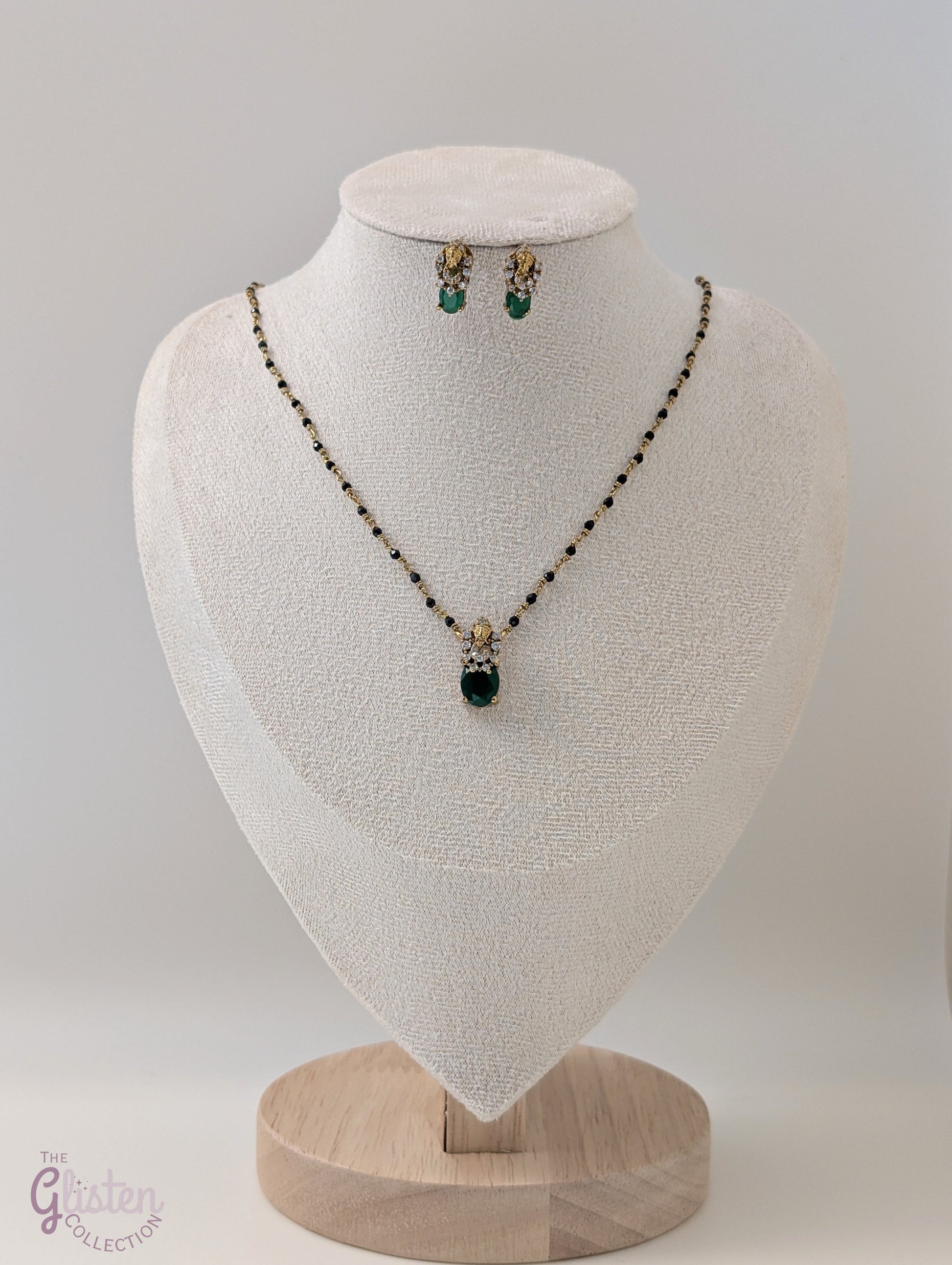 Black bead necklace with green stone pendant and matching earrings — minimal design ideal for daily wear and casual occasions.