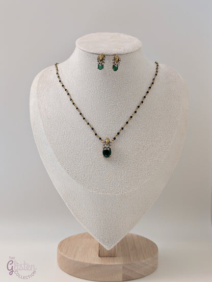 Black bead necklace with green stone pendant and matching earrings — minimal design ideal for daily wear and casual occasions.