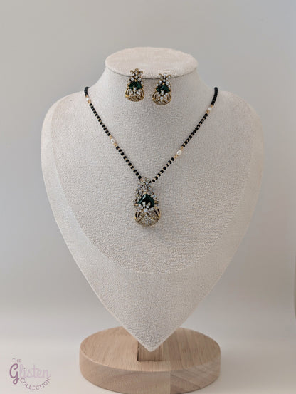 Bead-linked necklace with central green stone and matching earrings — elegant jewellery for festive and everyday wear.