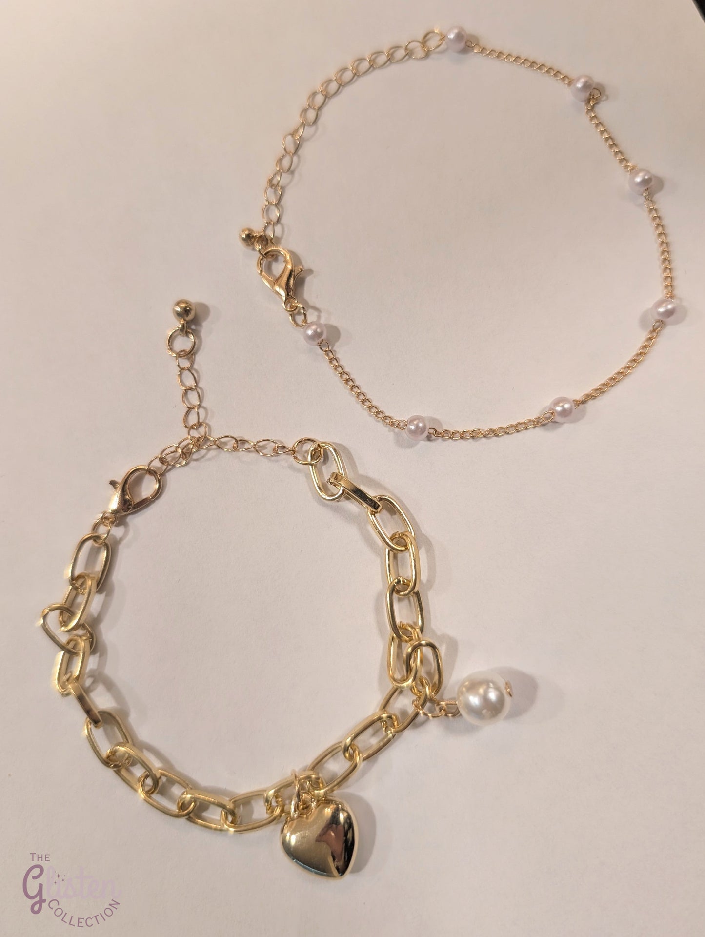 Set of two bracelets – one with heart charm and pearls, one with full artificial pearls, perfect for layering and daily wear.