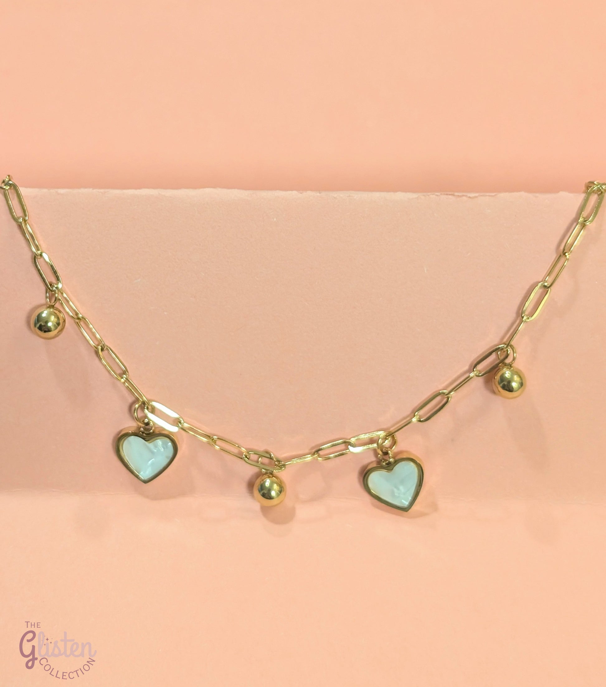 White heart and gold round charm bracelet, combining elegance and charm for a stylish, everyday accessory.