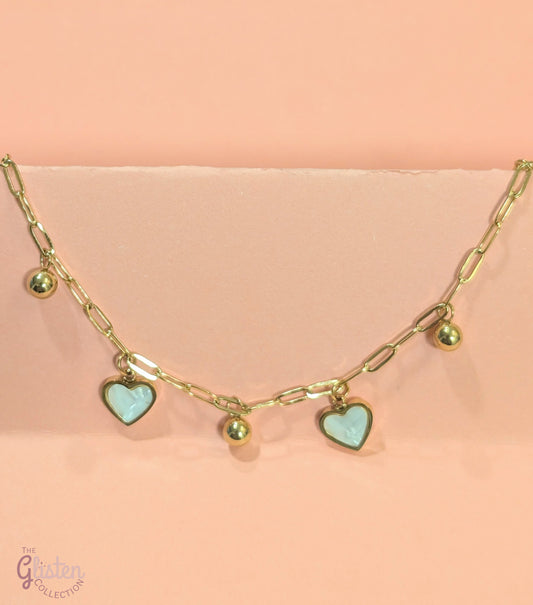White heart and gold round charm bracelet, combining elegance and charm for a stylish, everyday accessory.