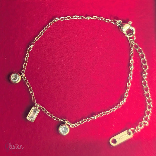 Pink charm geometric bracelet with circular and rectangular charms in pink, complemented by gold-plated links for a stylish and minimalist look.