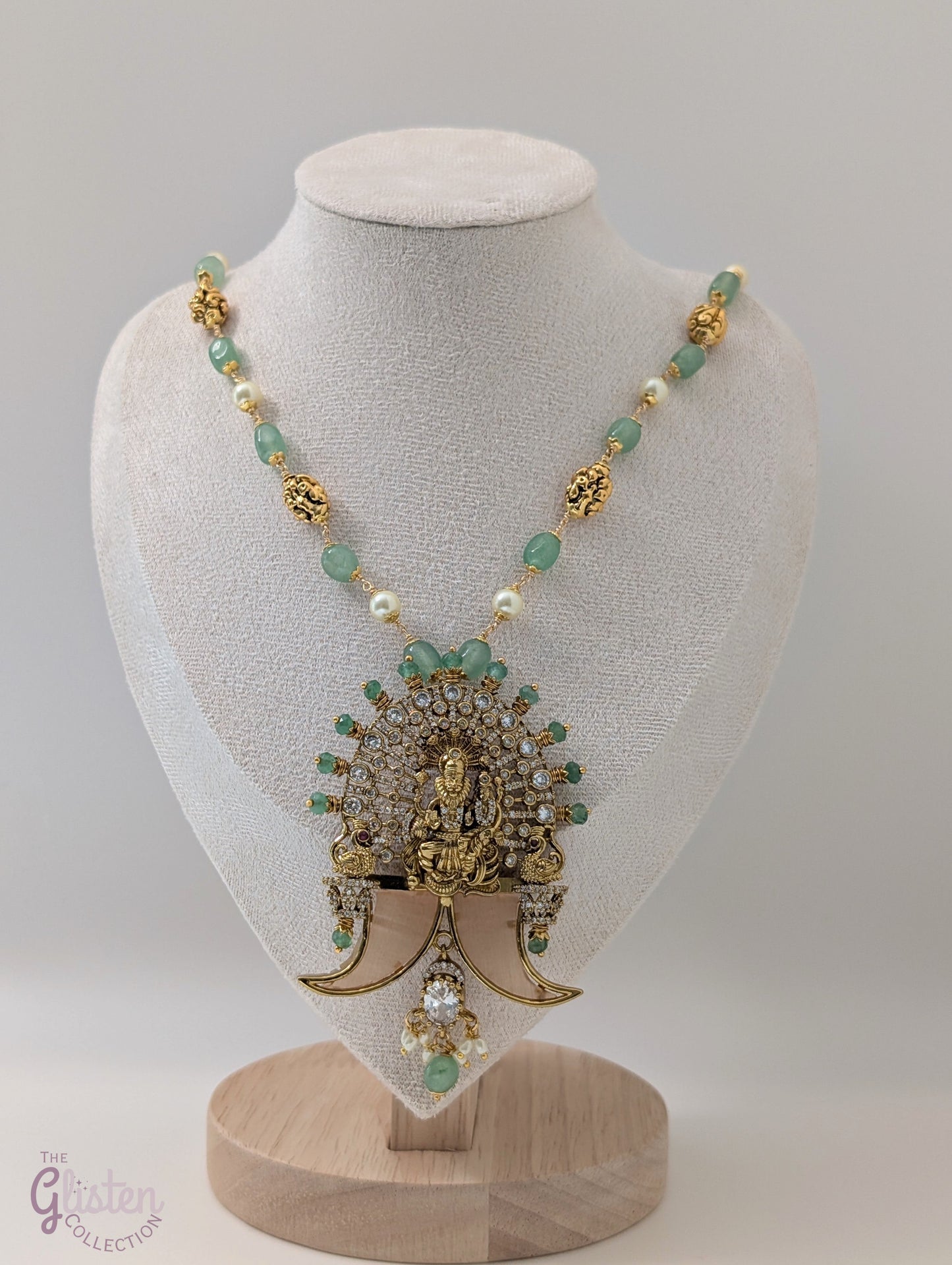 Long green beaded necklace with tiger nail–style pendant and white pearls — statement traditional jewellery ideal for lehengas, sarees, and festive occasions.