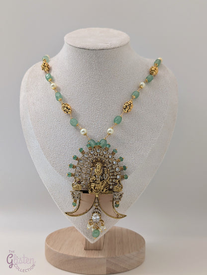 Long green beaded necklace with tiger nail–style pendant and white pearls — statement traditional jewellery ideal for lehengas, sarees, and festive occasions.