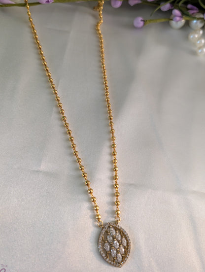Gold-tone short necklace with gold balls and leaf-shaped pendant adorned with stones — simple, elegant daily wear jewellery.