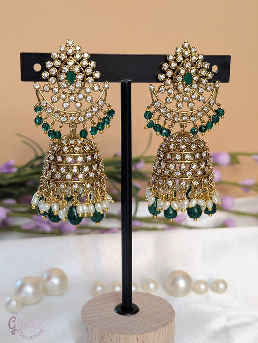 Moonlit Jhumka Charms earrings with crescent shape, green stones, and sparkling CZ details — perfect for enhancing special occasion looks.