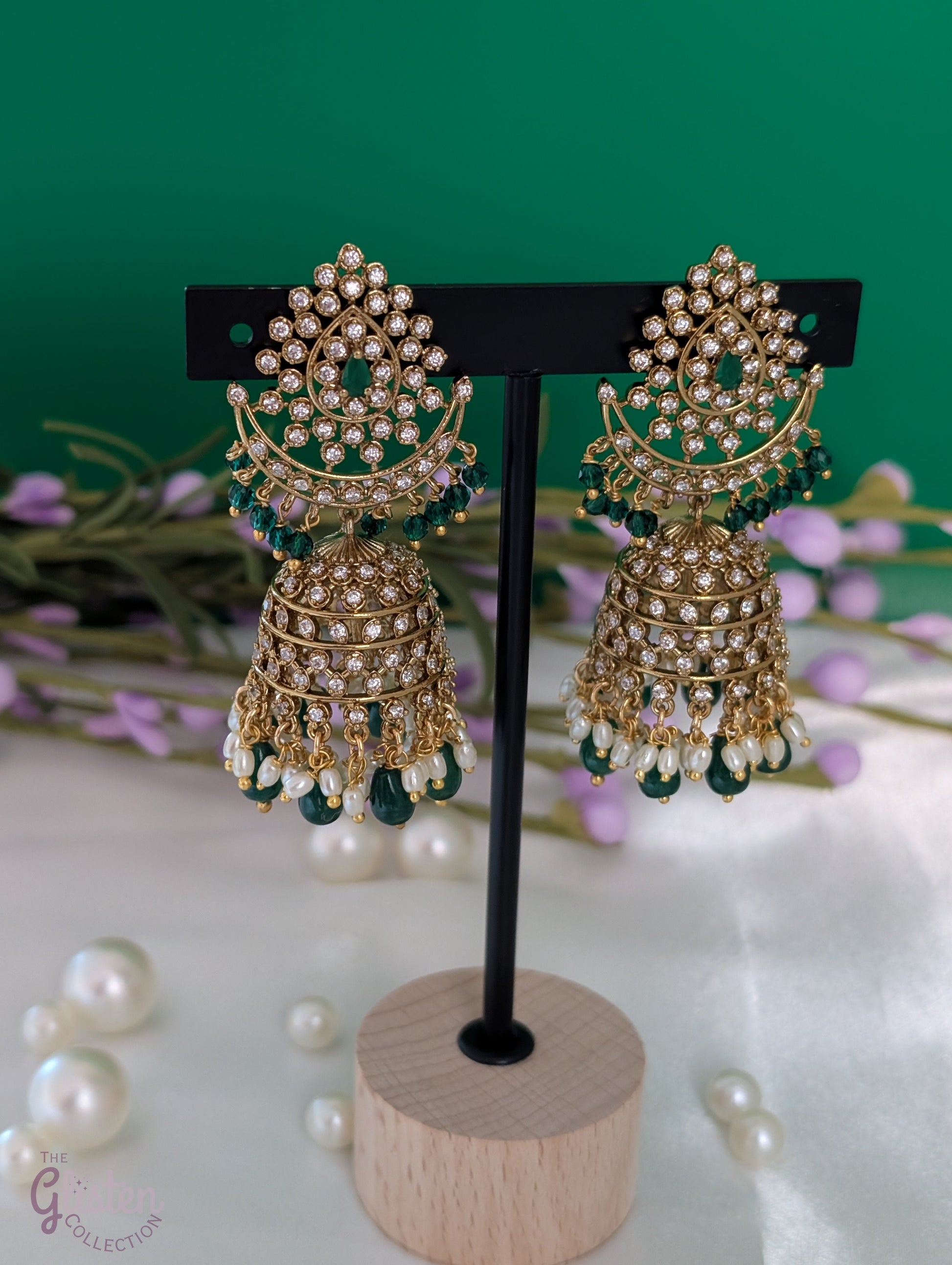 Moonlit Jhumka Charms earrings with crescent shape, green stones, and sparkling CZ details — perfect for enhancing special occasion looks.