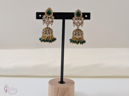 Emerald Flow Jhumkas with green stones, delicate accents, and green bead dangles — perfect for simple yet festive looks at parties and special occasions.