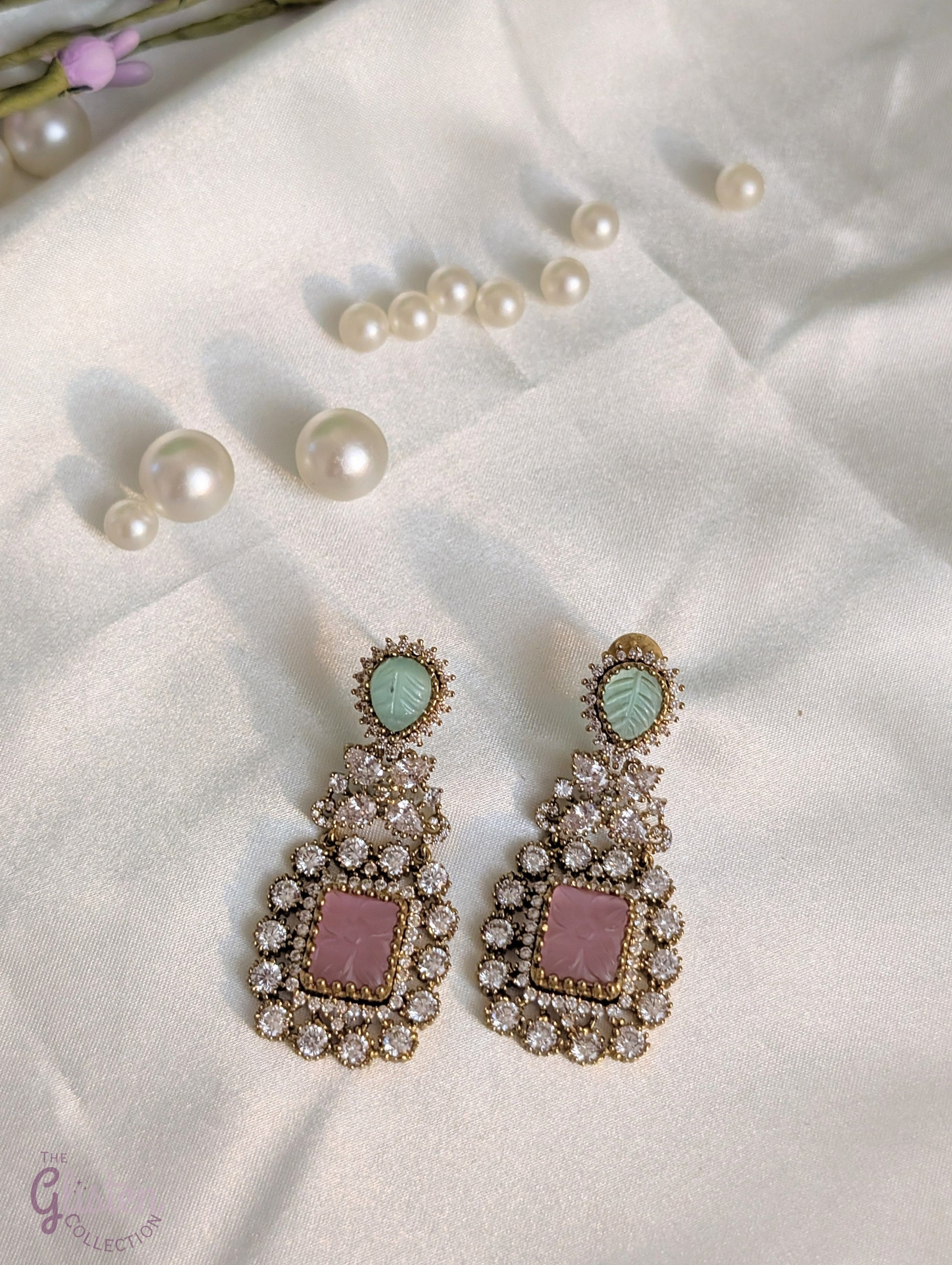 Rose Dew Drops earrings with pink square base, green tear-drop top, and Moissanite stones — ideal for modern or traditional occasions.