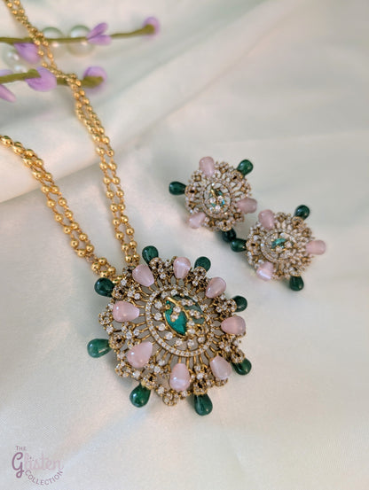Gold-tone double-chain necklace with floral pendant featuring pink, green, and CZ stones, ideal for special occasions or enhancing simple outfits.
