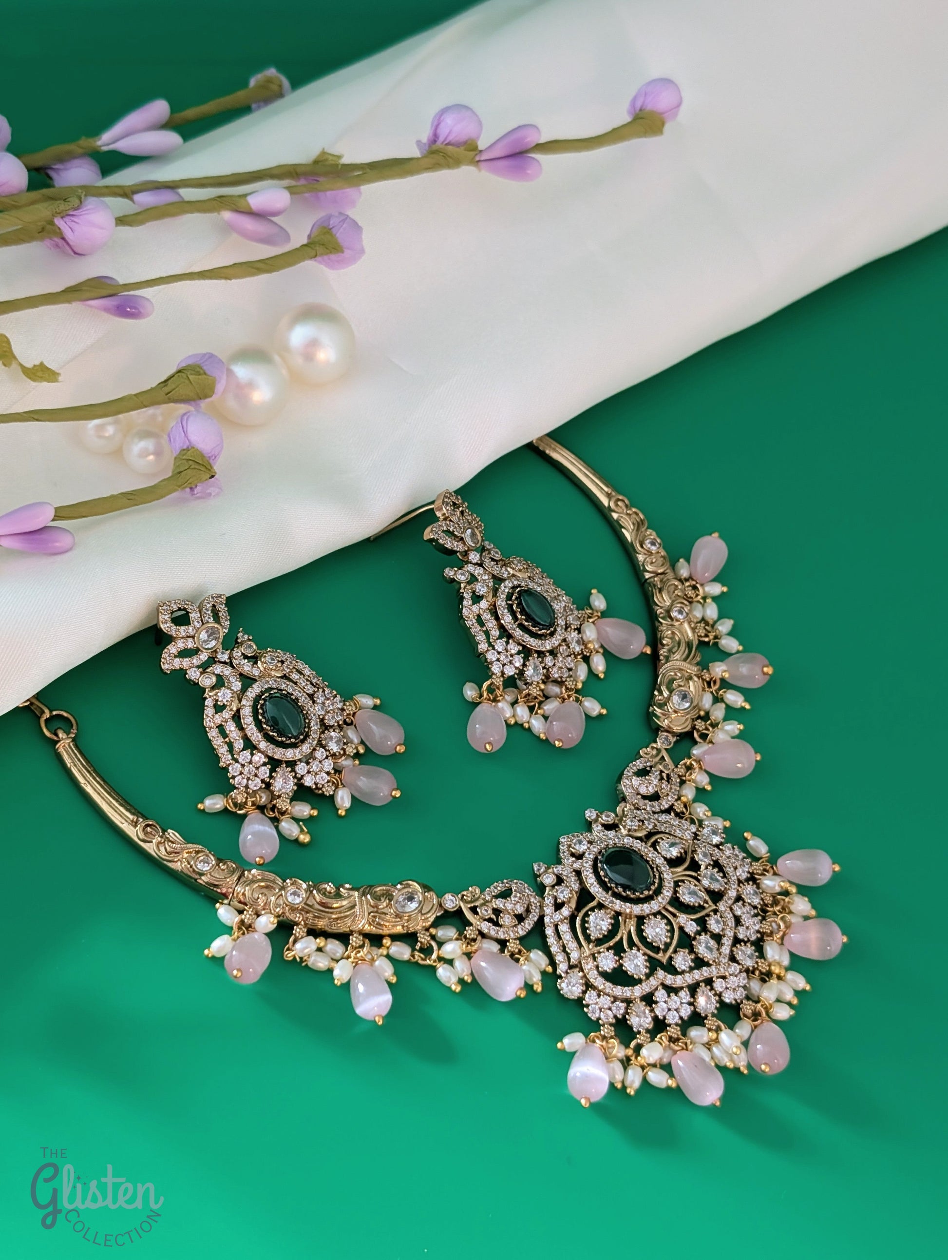 Statement necklace and earrings set with green center stone, pink beads, and white accents — perfect for weddings, festive looks, and party wear.