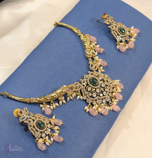 Statement necklace and earrings set with green center stone, pink beads, and white accents — perfect for weddings, festive looks, and party wear.