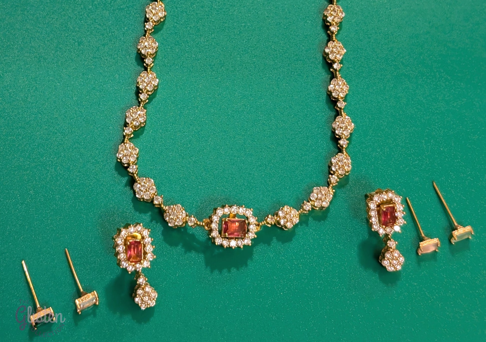 Matte gold-plated American Diamond necklace set with floral motifs and four interchangeable AD stones, ideal for formal and festive occasions.