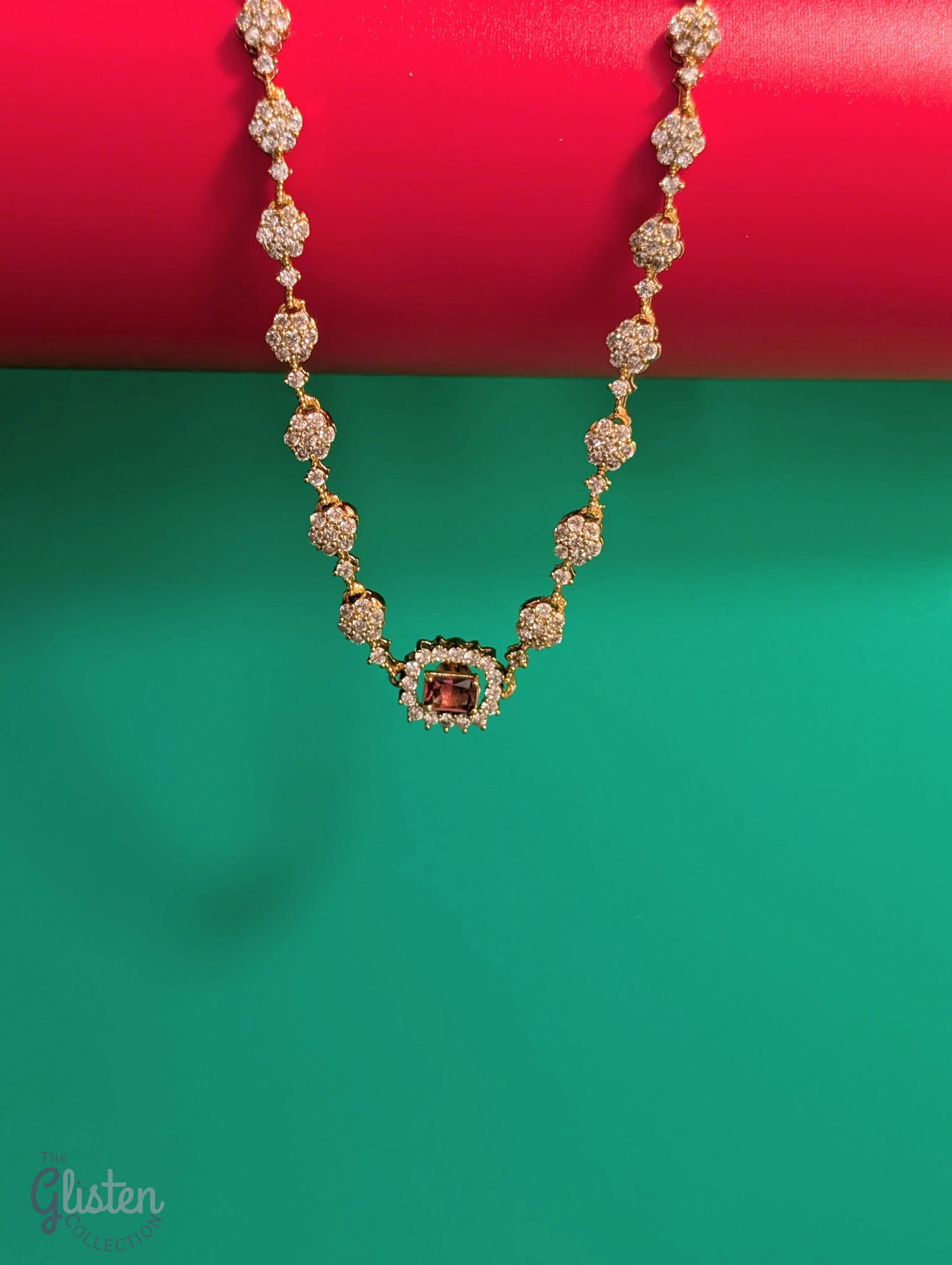 Matte gold-plated American Diamond necklace set with floral motifs and four interchangeable AD stones, ideal for formal and festive occasions.