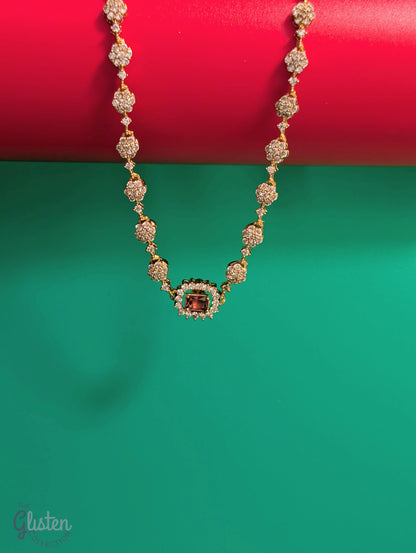 Matte gold-plated American Diamond necklace set with floral motifs and four interchangeable AD stones, ideal for formal and festive occasions.