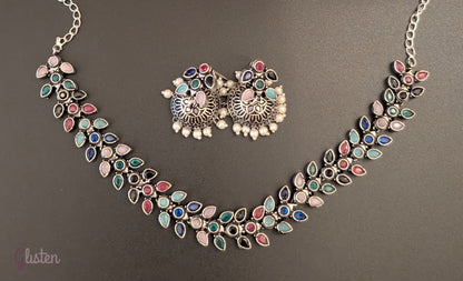 Leaf design oxidized German silver necklace set with colorful teardrop stones and matching pearl jhumkas — perfect for simple ethnic wear or festive style.