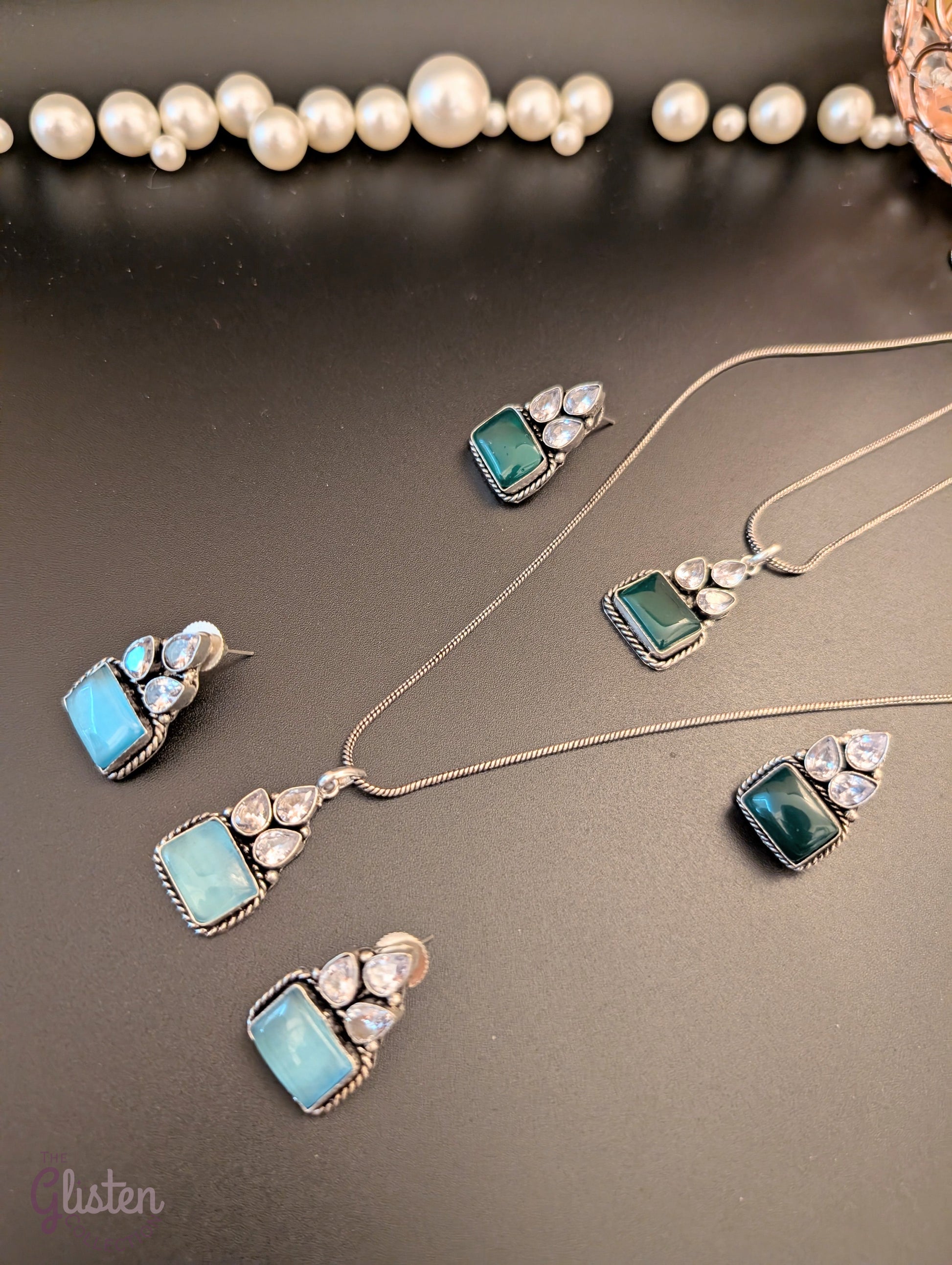 Oxidized silver pendant set with rectangular green stones, twisted rope frame, and American Diamonds — perfect for festive, ethnic, or everyday looks.