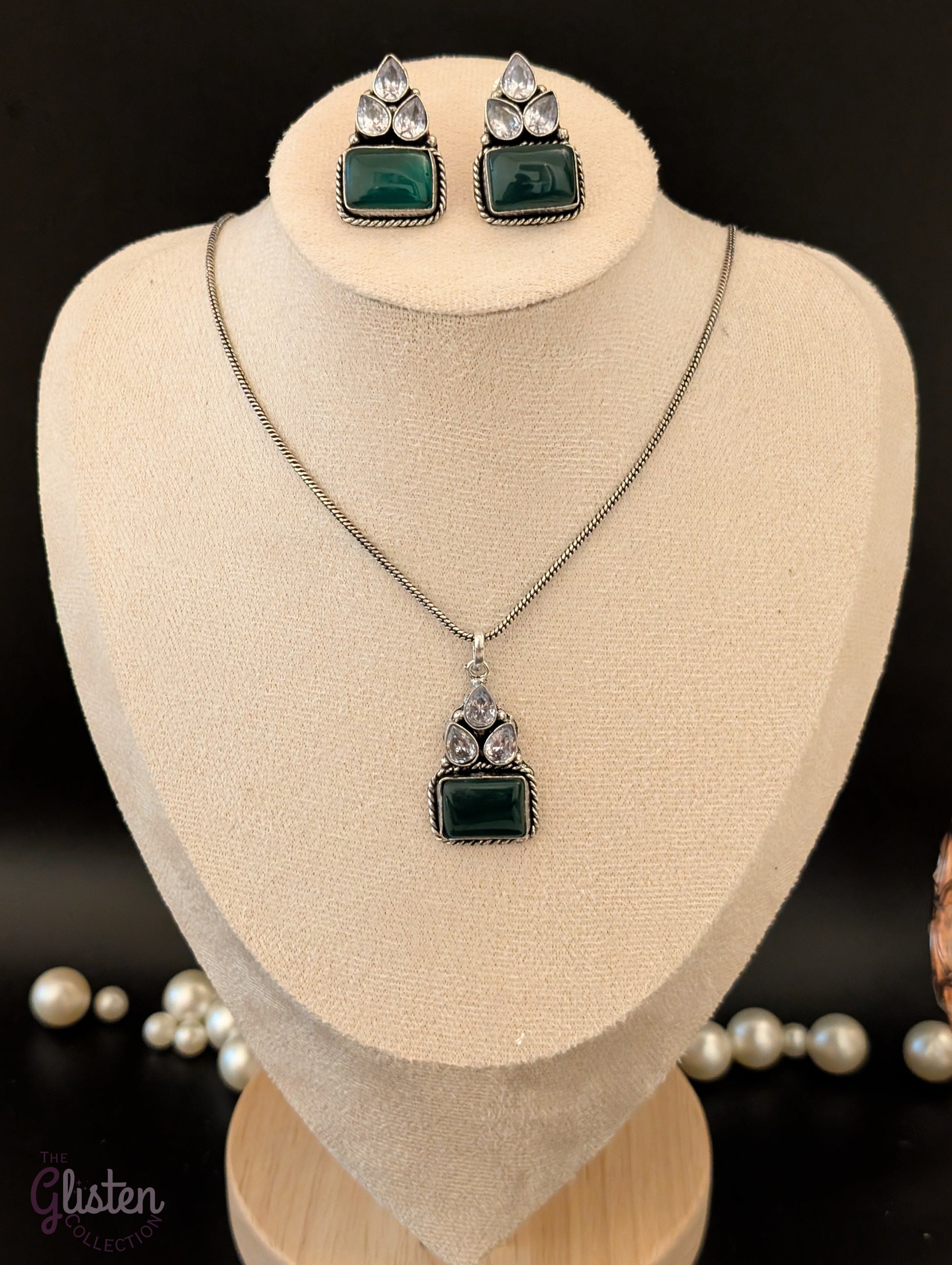 Oxidized silver pendant set with rectangular green stones, twisted rope frame, and American Diamonds — perfect for festive, ethnic, or everyday looks.