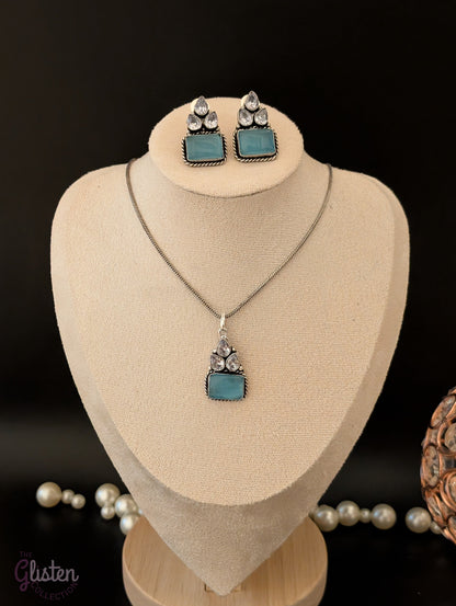 Oxidized silver pendant set with rectangular green stones, twisted rope frame, and American Diamonds — perfect for festive, ethnic, or everyday looks.