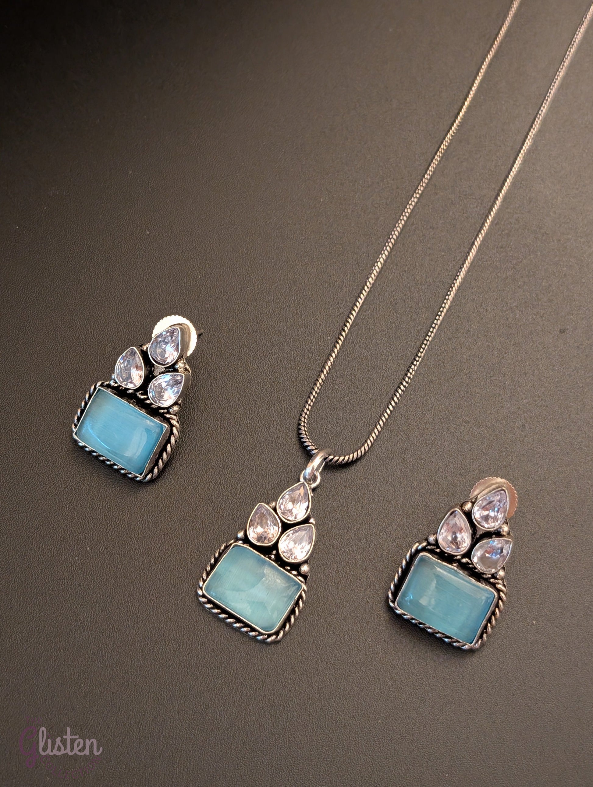 Oxidized silver pendant set with rectangular green stones, twisted rope frame, and American Diamonds — perfect for festive, ethnic, or everyday looks.