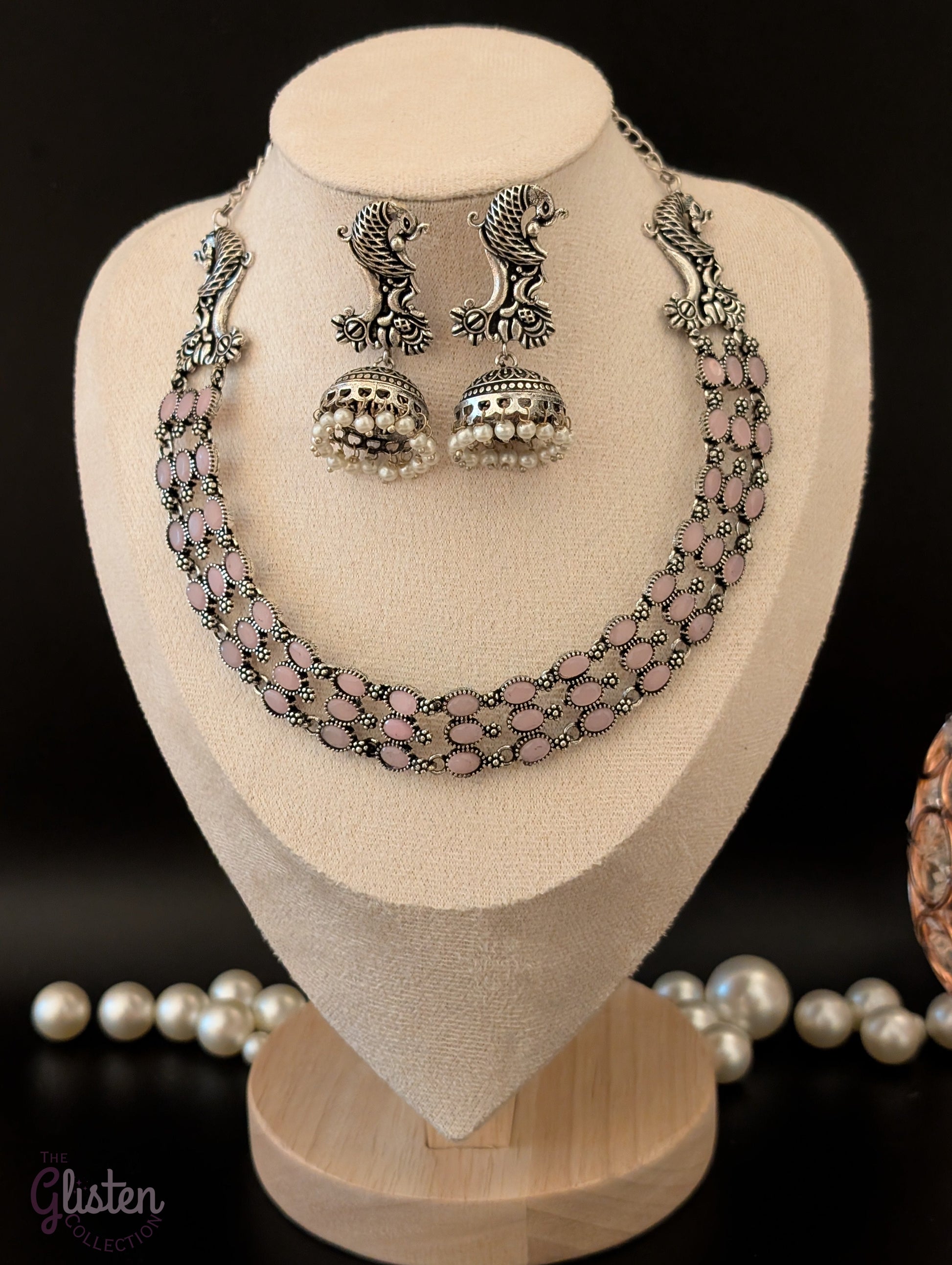 Three-layered oxidized German silver necklace with peacock motifs and matching pearl jhumkas — ideal for weddings, traditional functions, and festive occasions.