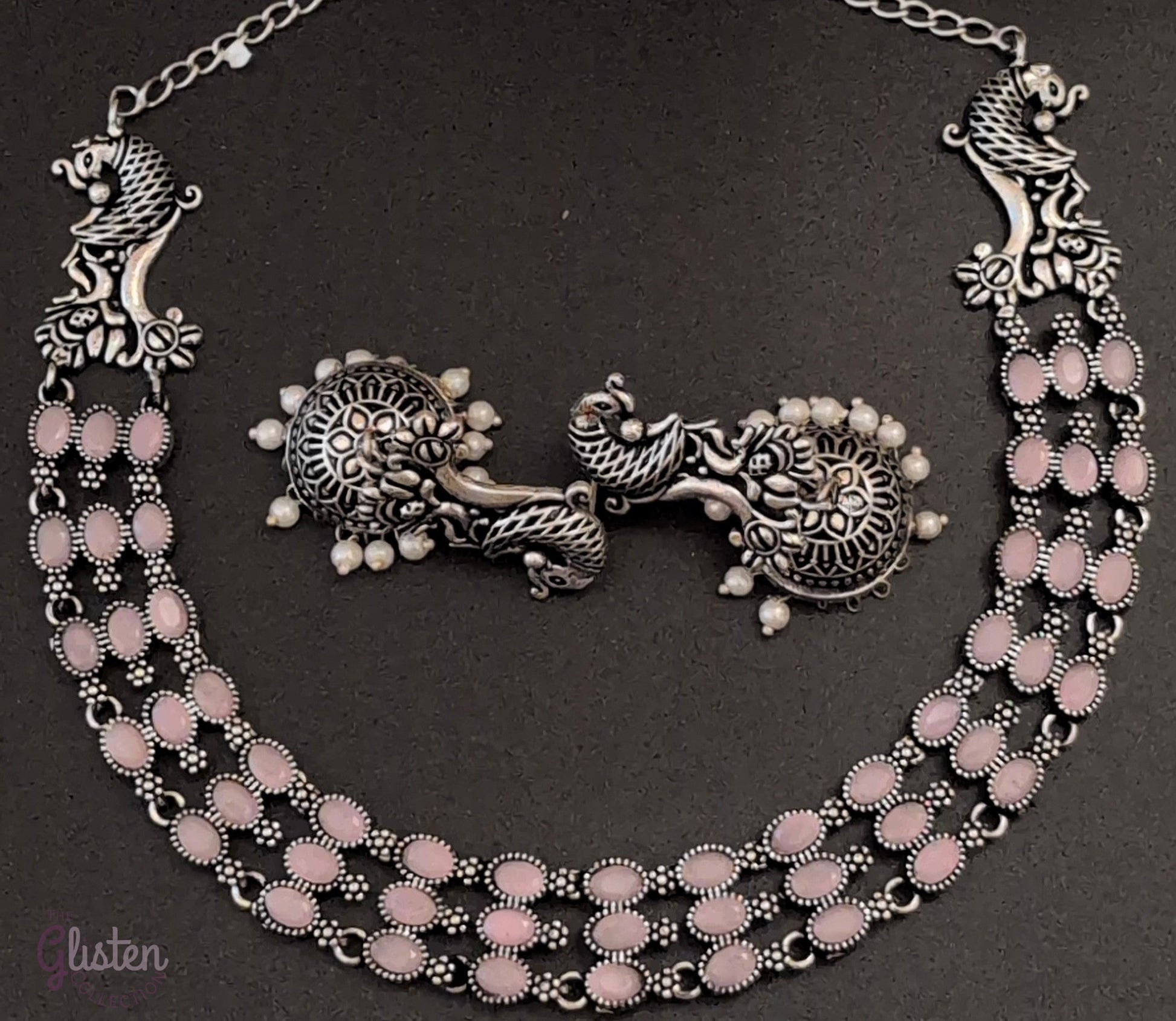 Three-layered oxidized German silver necklace with peacock motifs and matching pearl jhumkas — ideal for weddings, traditional functions, and festive occasions.