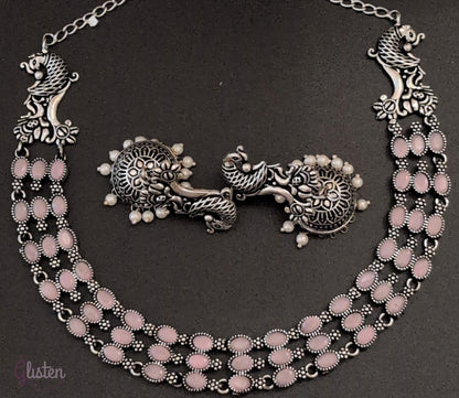 Three-layered oxidized German silver necklace with peacock motifs and matching pearl jhumkas — ideal for weddings, traditional functions, and festive occasions.