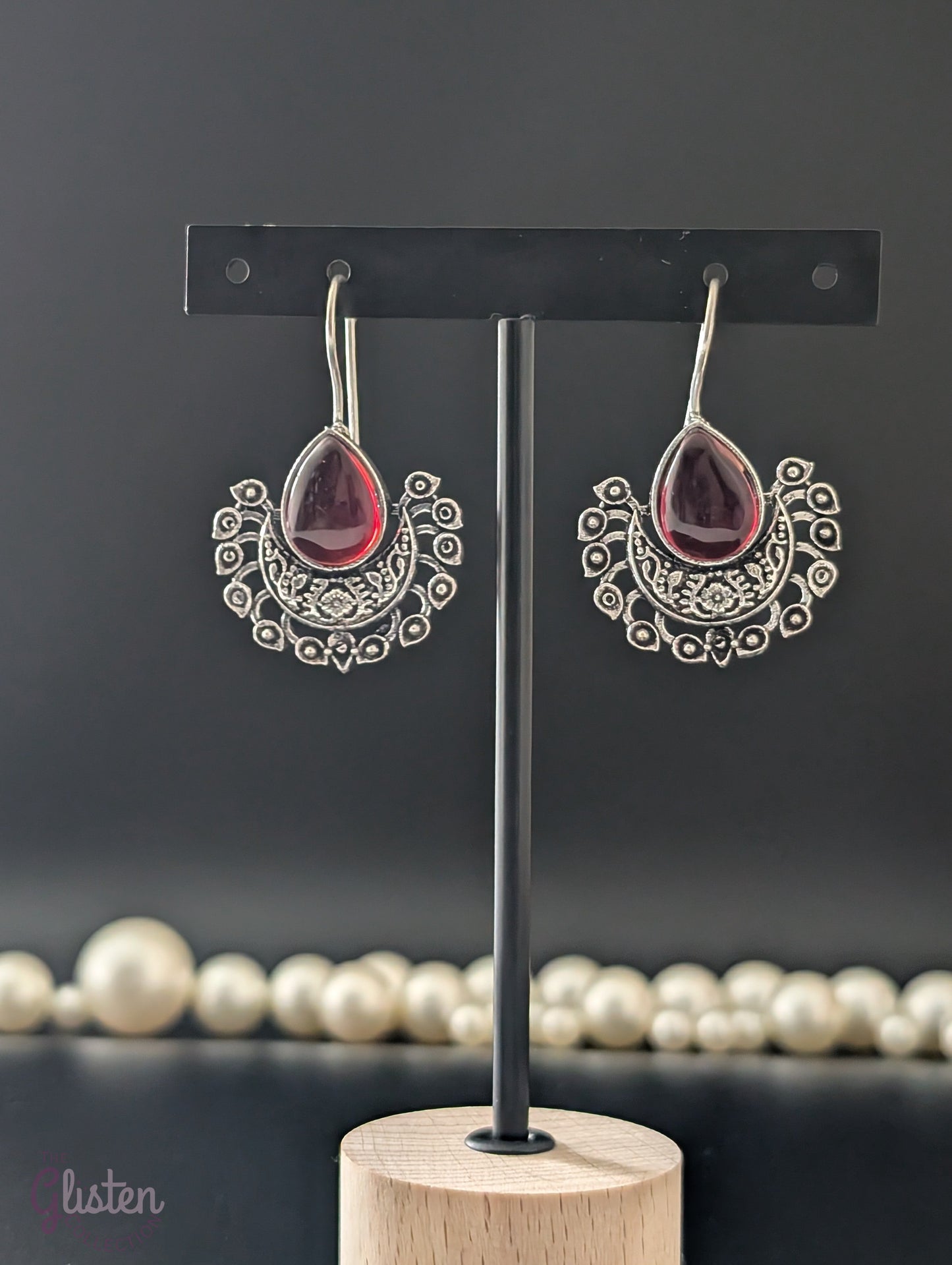 Boho-style oxidized earrings with a single ocean blue teardrop stone from The Glisten Collection.