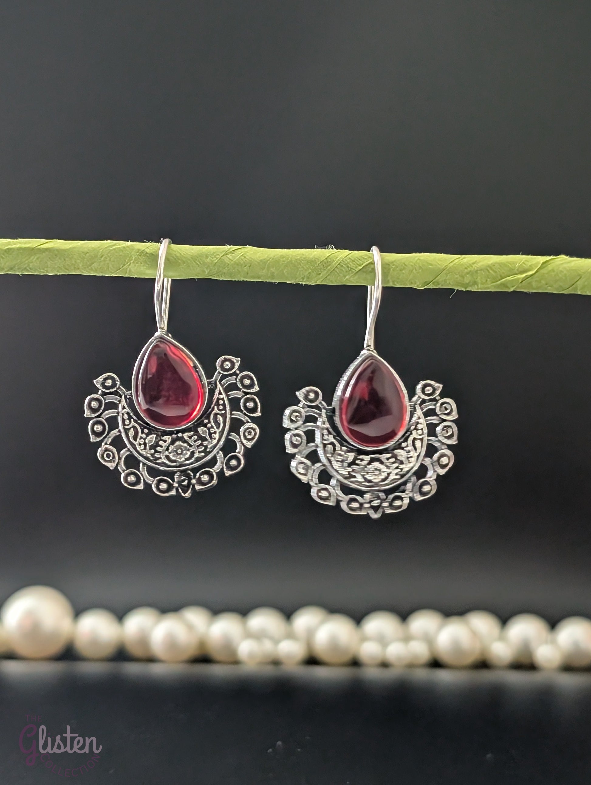 Boho-style oxidized earrings with a single ocean blue teardrop stone from The Glisten Collection.